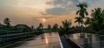 Sunset on solar panels in a village